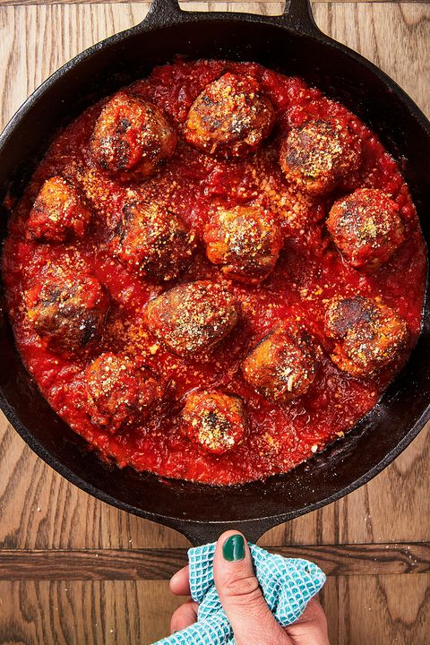 meatballs in red sauce in a black cast iron pan