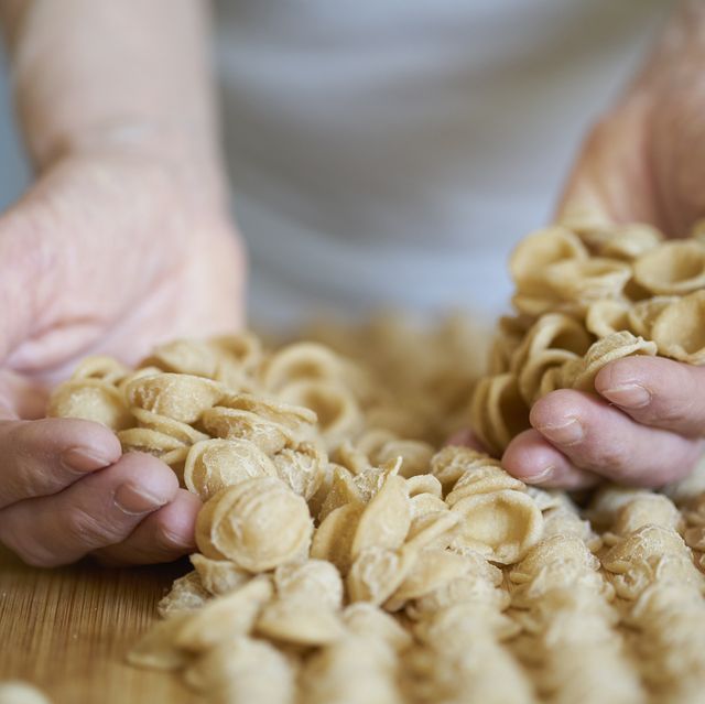 hands of senior woman holding homemade orecchiette orecchiette are a pasta typical of apulia, a region of southern italy their name comes from their shape, which resembles a small ear