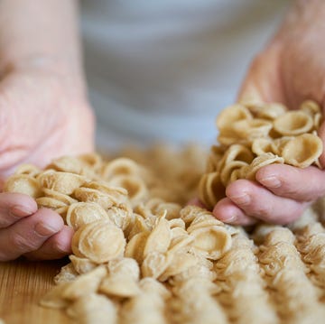 hands of senior woman holding homemade orecchiette orecchiette are a pasta typical of apulia, a region of southern italy their name comes from their shape, which resembles a small ear