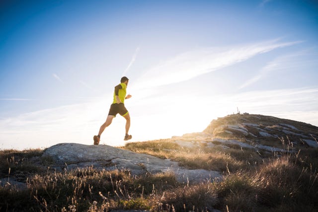 italy, man running on mountain trail