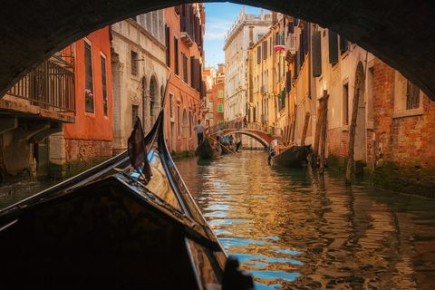 italy, veneto, venice, gondola under bridge