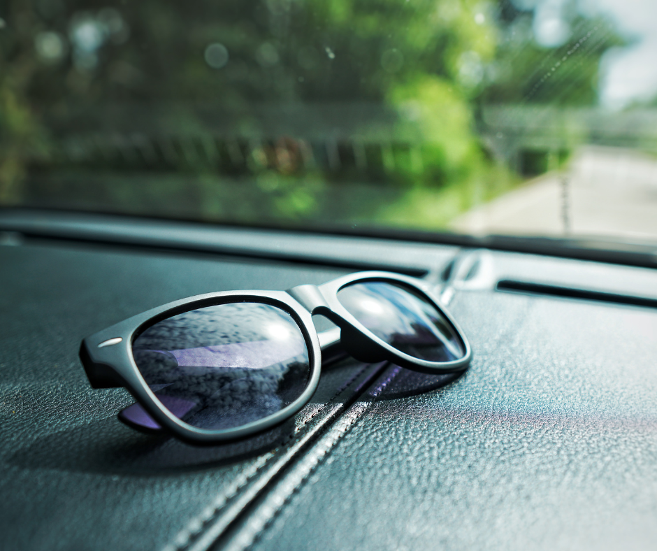 sunglasses resting on a car dashboard