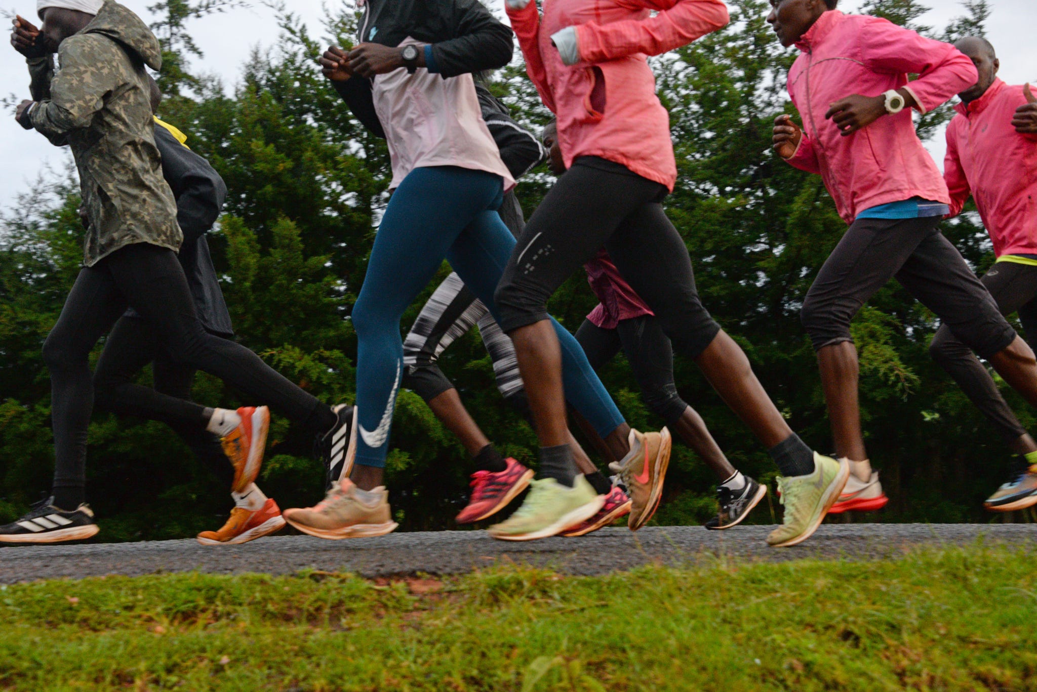 women in pink jackets running