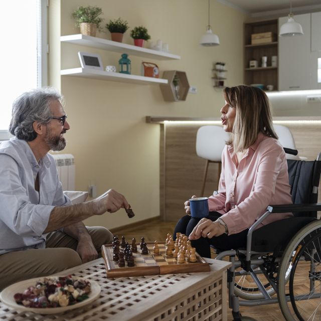 man and woman in a wheelchair playing chess