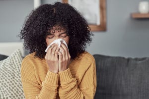 woman blowing nose