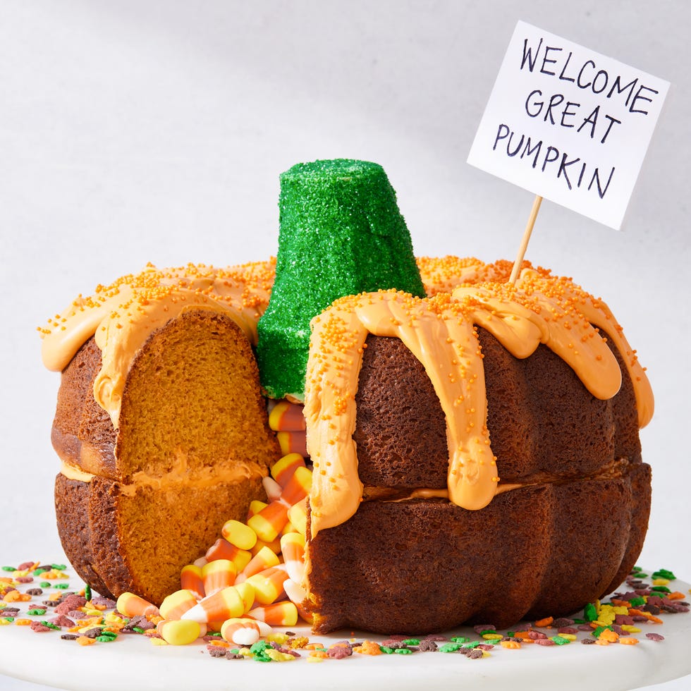 two pumpkin bundt cakes stacked on each other, filled with candy corn, and decorated to look like a pumpkin