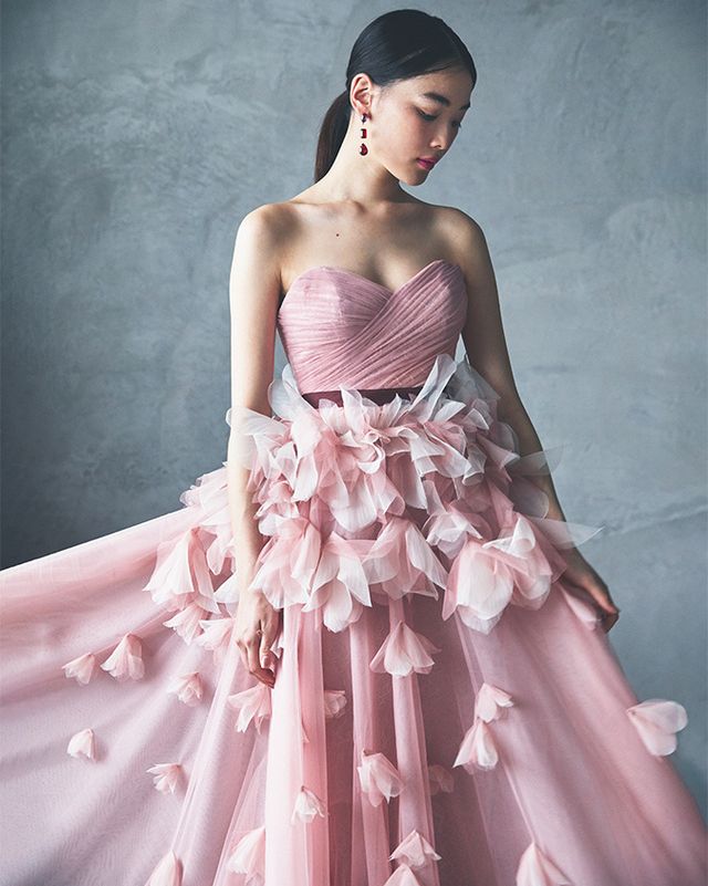 イツワのピンクの花びらドレスを着たモデル。