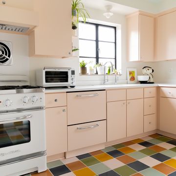 retro style kitchen with blush pink cabinets and checkered floors