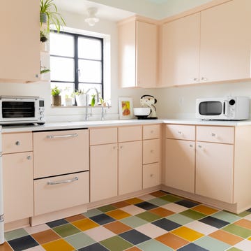 retro style kitchen with blush pink cabinets and checkered floors