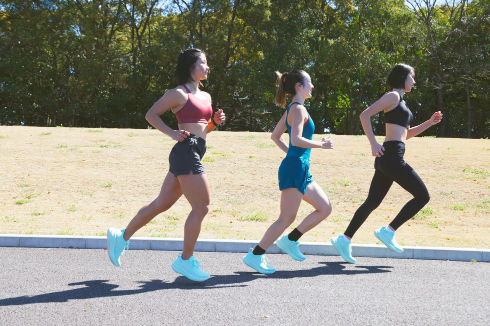 a group of women running on a road