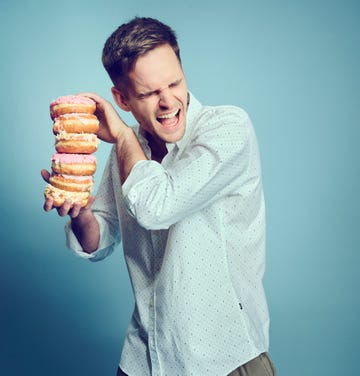a person holding a stack of donuts