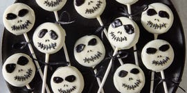 white chocolate covered oreo pops decorated as jack skellington with icing