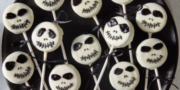 white chocolate covered oreo pops decorated as jack skellington with icing