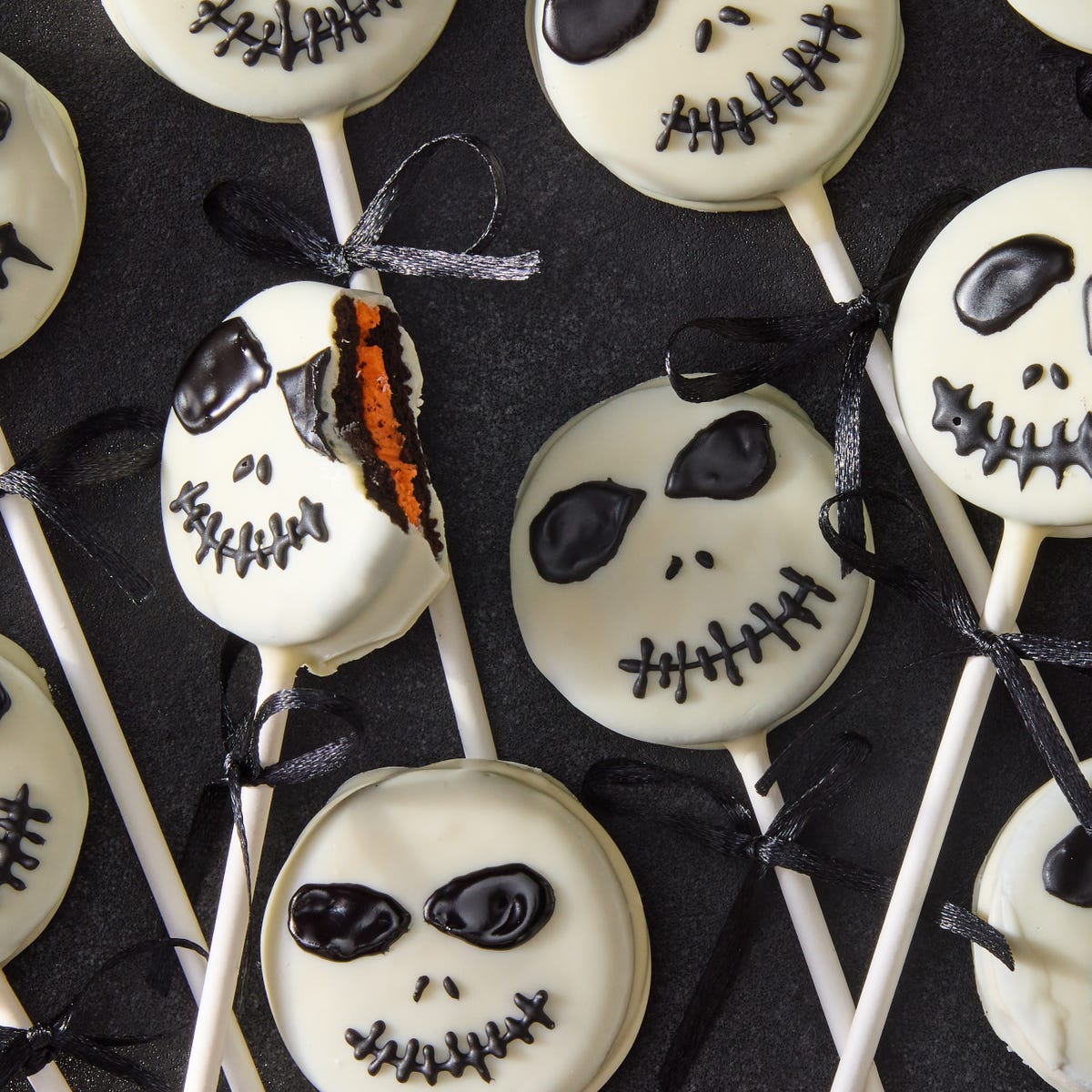 white chocolate covered oreo pops decorated as jack skellington with icing