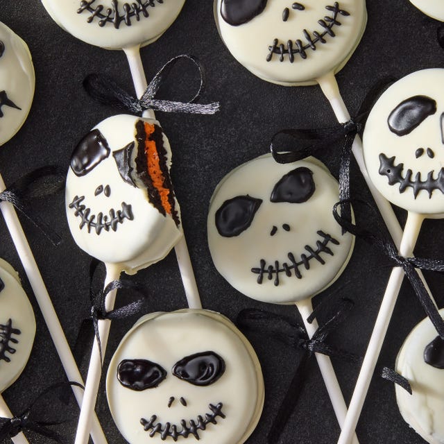 white chocolate covered oreo pops decorated as jack skellington with icing
