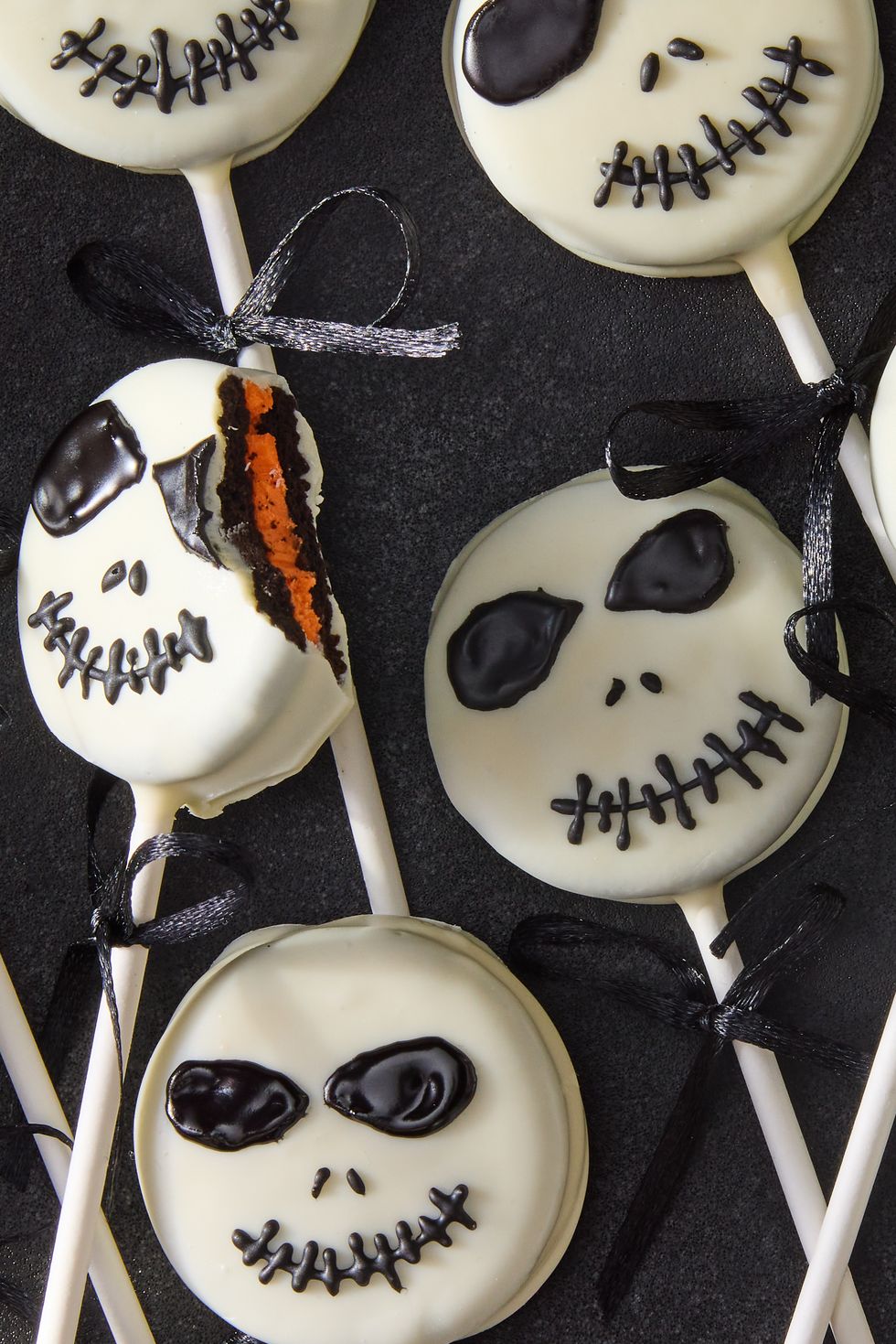 white chocolate covered oreo pops decorated as jack skellington with icing