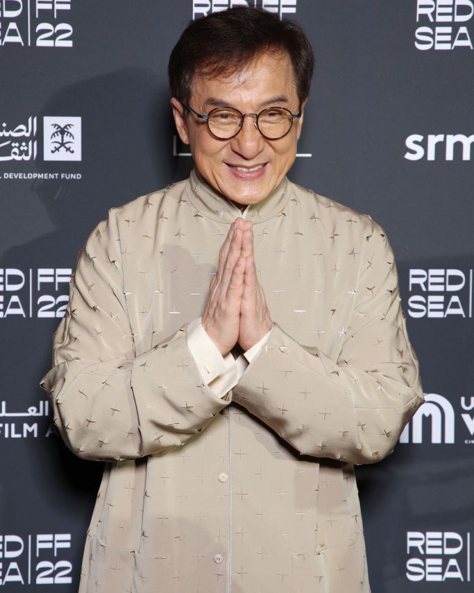 jackie chan smiling for a photograph at the red sea film festival