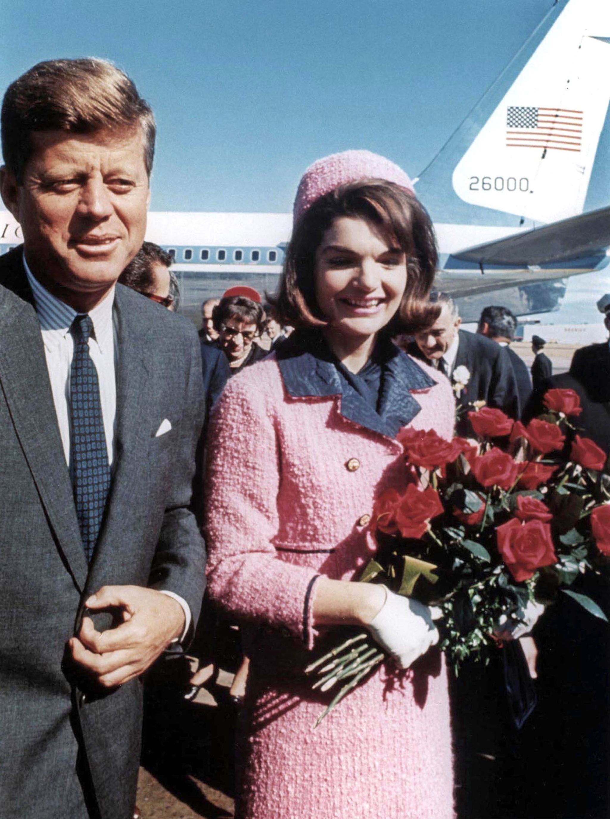 President John Kennedy and his wife Jackie, wearing strawberry-pink Chanel suit , arriving at Dallas airport (the day of John\'s assassination) November 22, 1963
