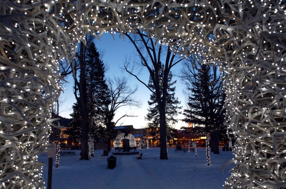 Grand Tetons, Wyoming christmas lights adorn antler arches in jackson wyomings city center