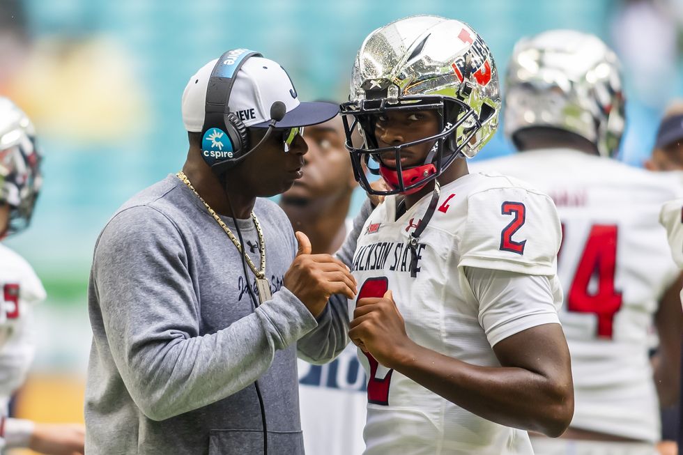 deion sanders talking to his quarterback son shedeur sanders during a football game