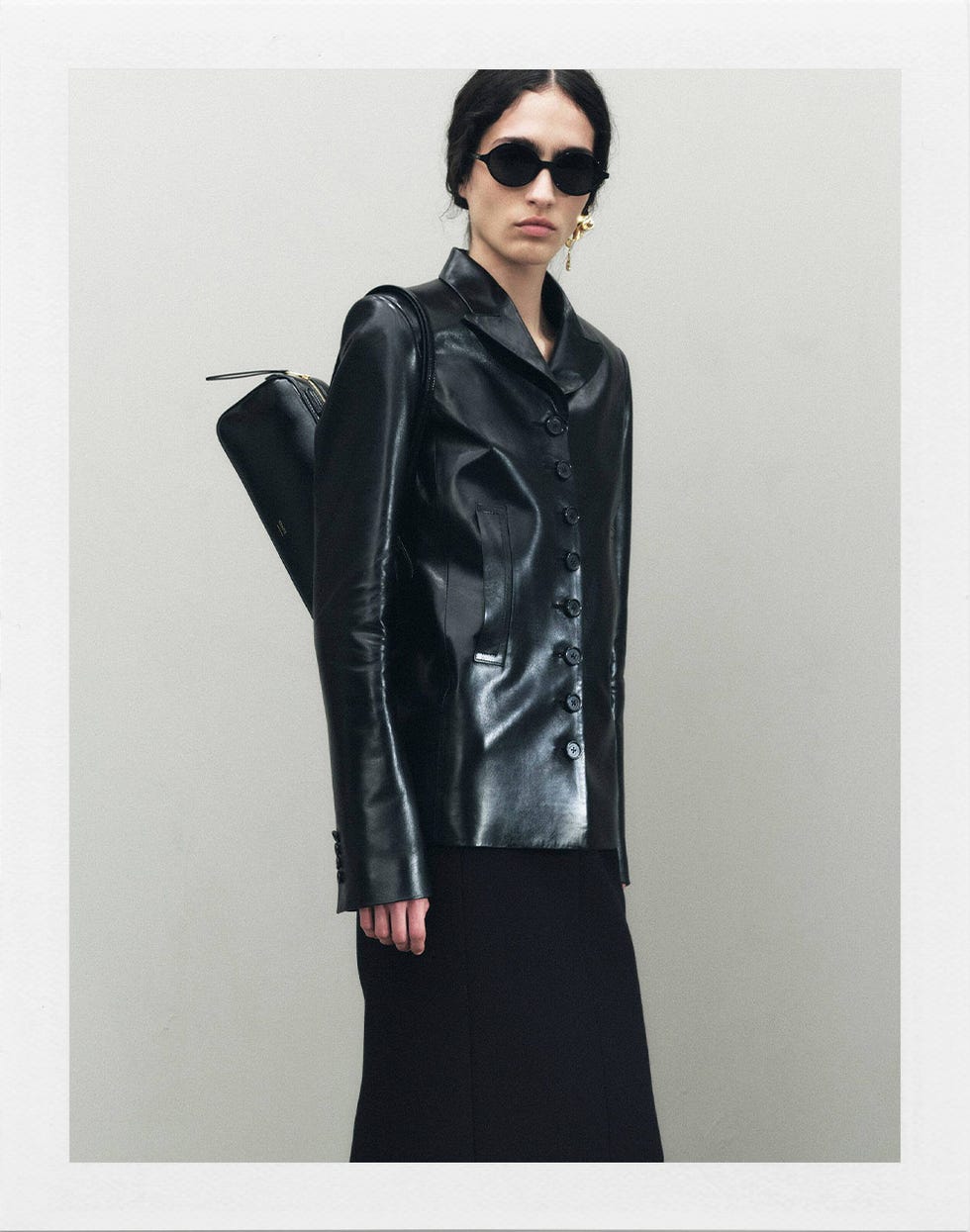 fashionable outfit featuring a black leather jacket and a sleek black skirt