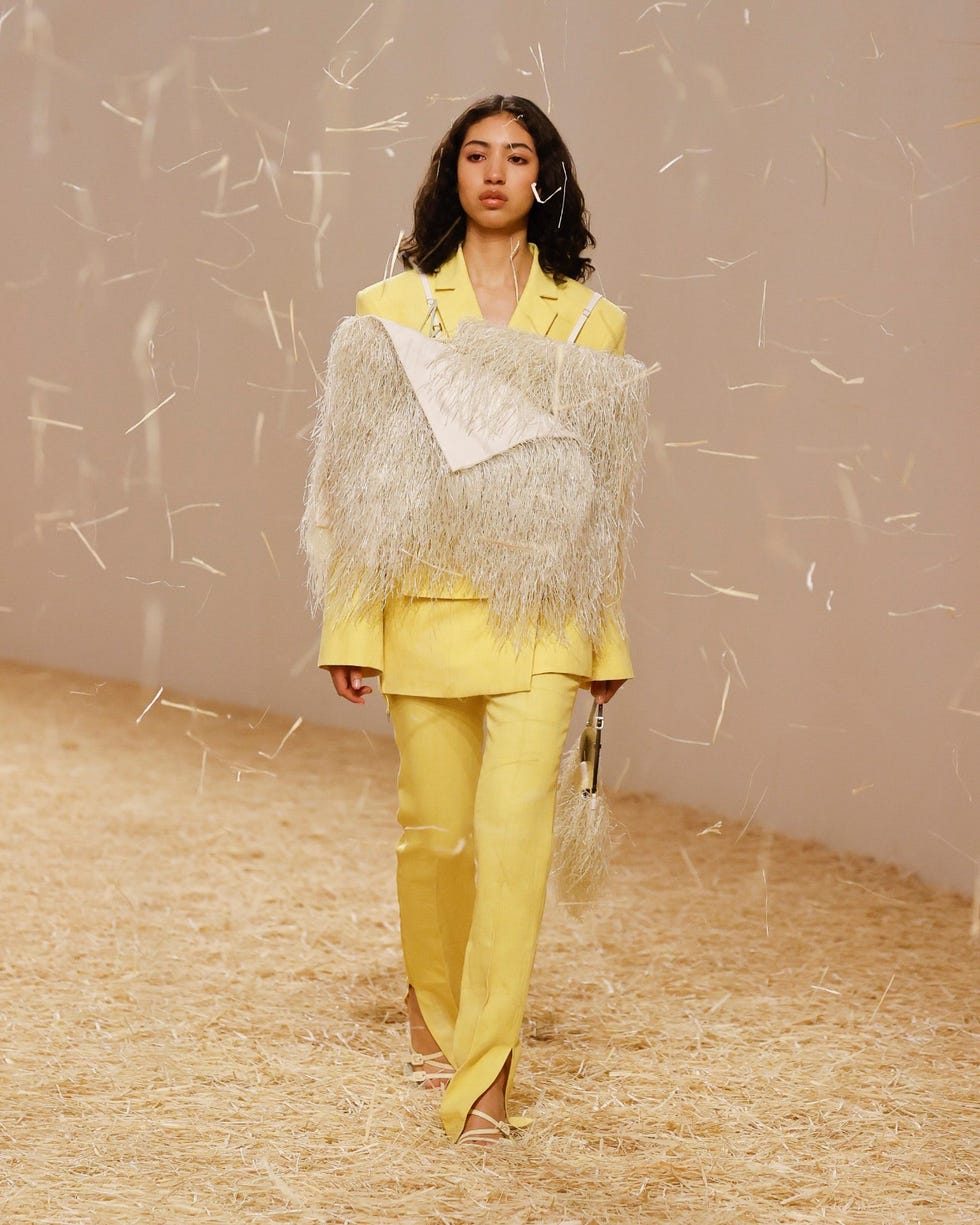 a model wears a jacquemus suit in a roundup of spring 2023 fashion trends worth shopping