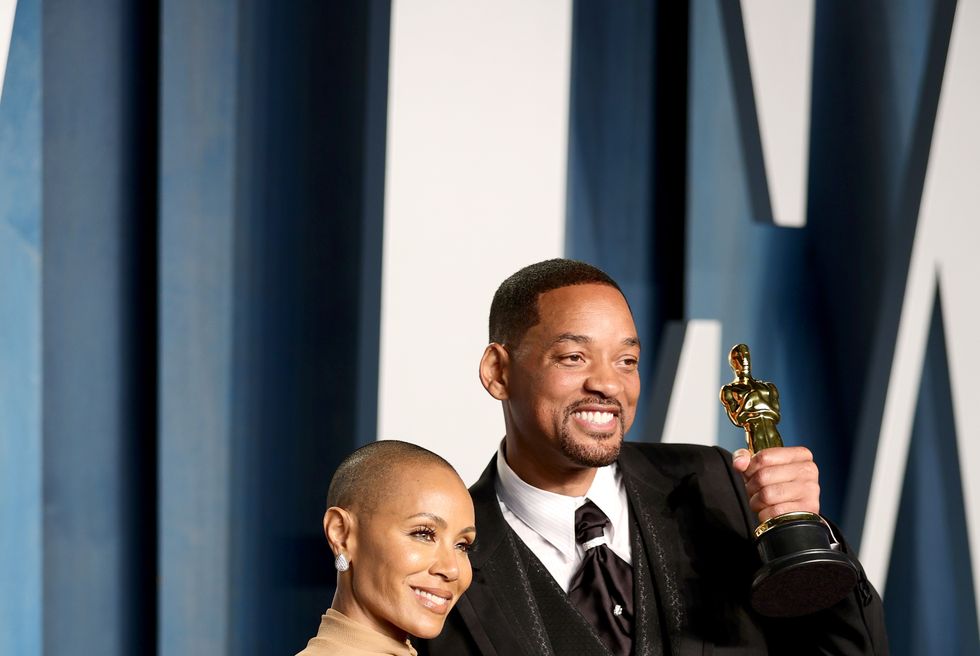 jada pinkett smith and will smith smile for photos, he holds an oscar statuette