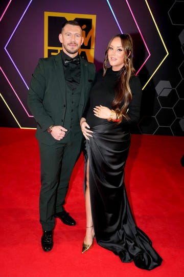 jake ankers, charlotte crosby posing together on the red carpet at the mtv emas