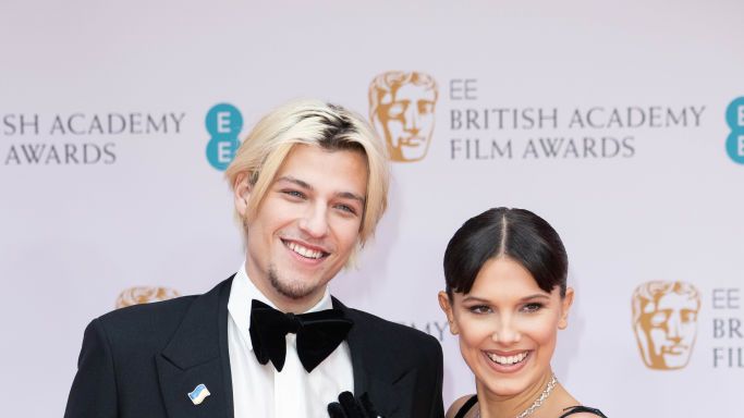 Millie Bobby Brown Attends The BAFTAs 2022 With Boyfriend Jake Bongiovi