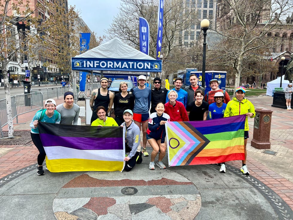 group of runners at boston marathon holding lgbtqia and nonbinary pride flags