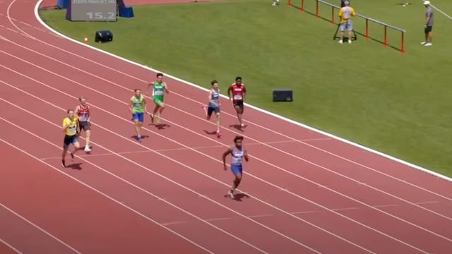 a group of people running on a track