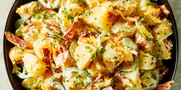 potato salad in a bowl with sliced jalapenos, bacon, and cheese