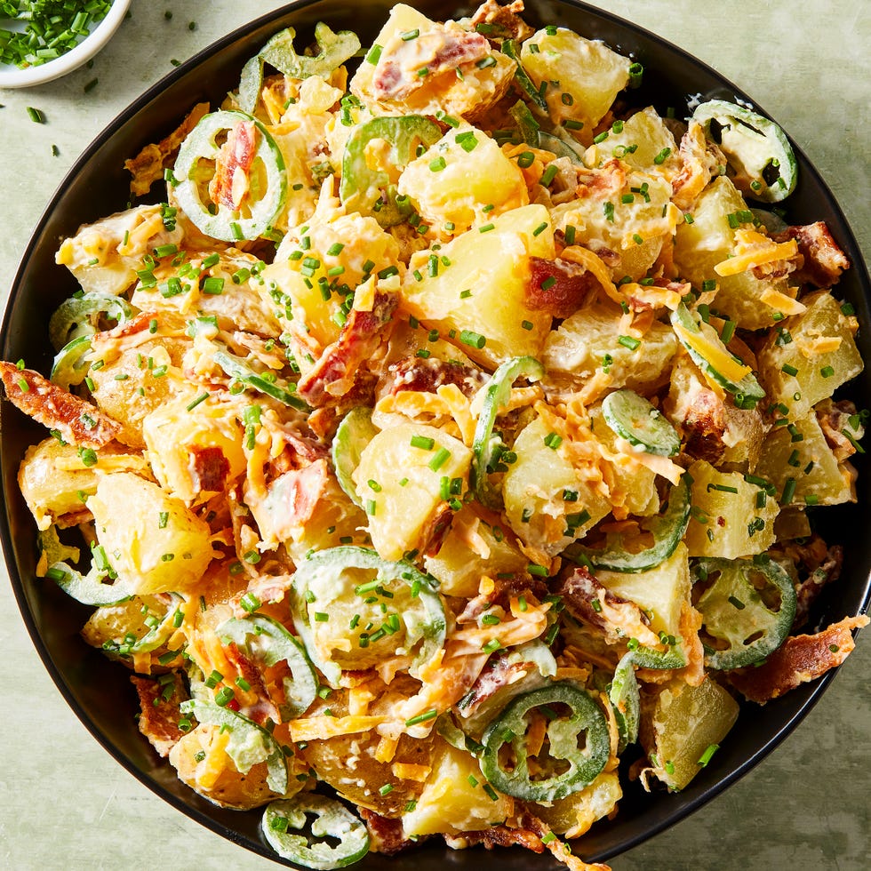 potato salad in a bowl with sliced jalapenos, bacon, and cheese