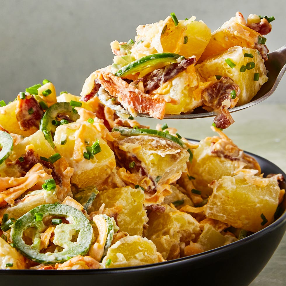 potato salad in a bowl with sliced jalapenos, bacon, and cheese