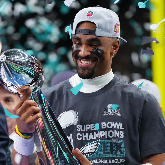 philadelphia eagles quarterback jalen hurts holding the lombardi trophy as confetti falls