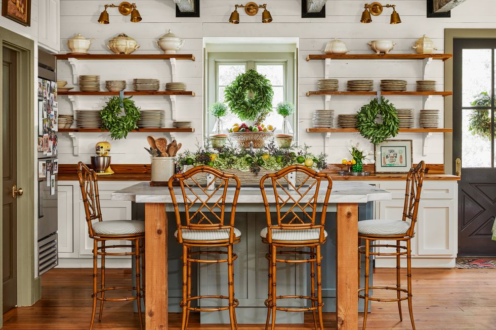 white cottage kitchen with wood shelves and green island