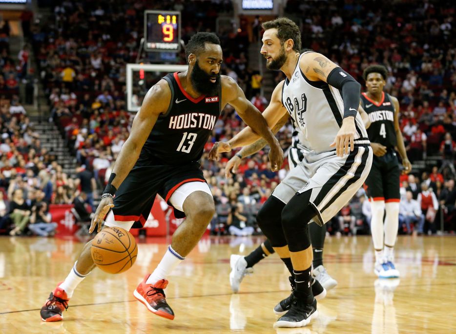 james harden dribbling a basketball in front of a defender during an nba game