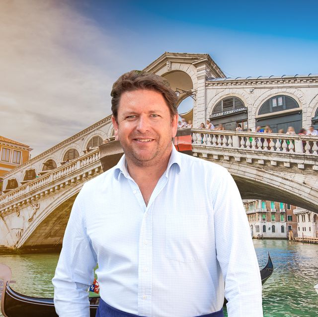 james martin standing in front of a venitian background featuring the rialto bridge