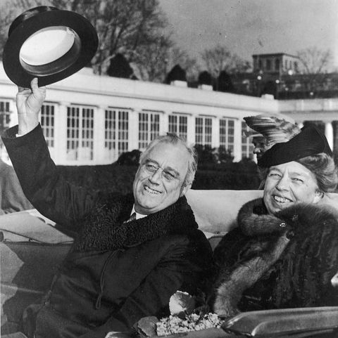 president franklin d roosevelt and wife eleanor roosevelt smiling and waving from an open car returning from inauguration ceremonies, january 20, 1941