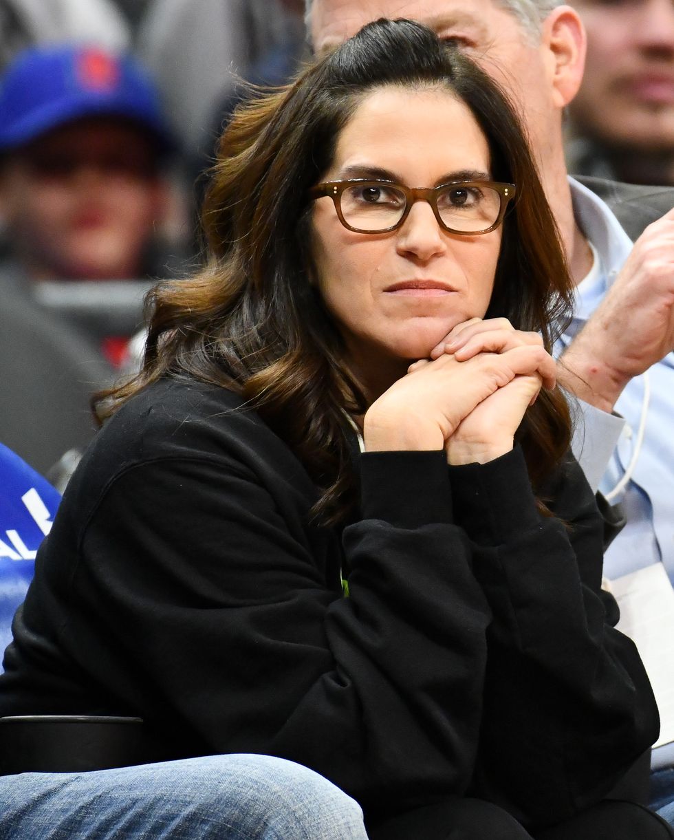 jami gertz sitting courtside at a basketball game with her head resting on her hands