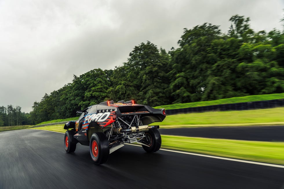 ford raptor t1 plus dakar racer bashing through a puddle