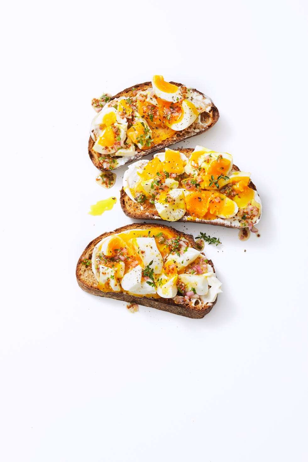 jammy egg toasts with fresh herbs on top