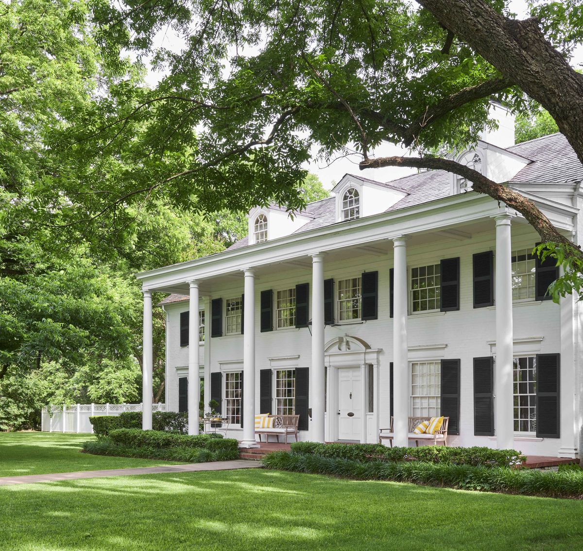 a three story white colonial home was designed by noted architect