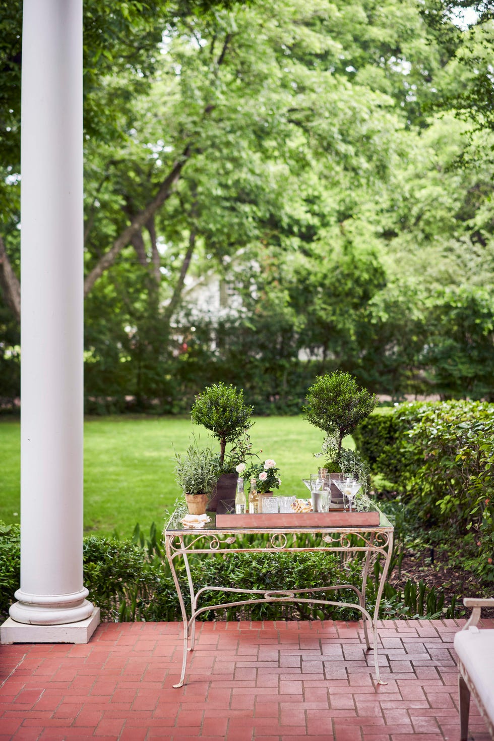 dry vodka martinis are served from a 1940s garden table on the front porch