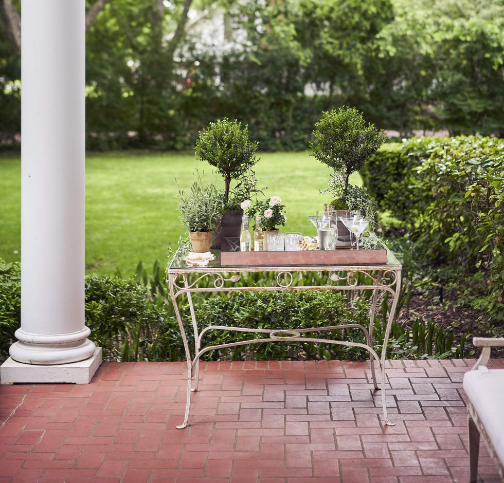 dry vodka martinis are served from a 1940s garden table on the front porch