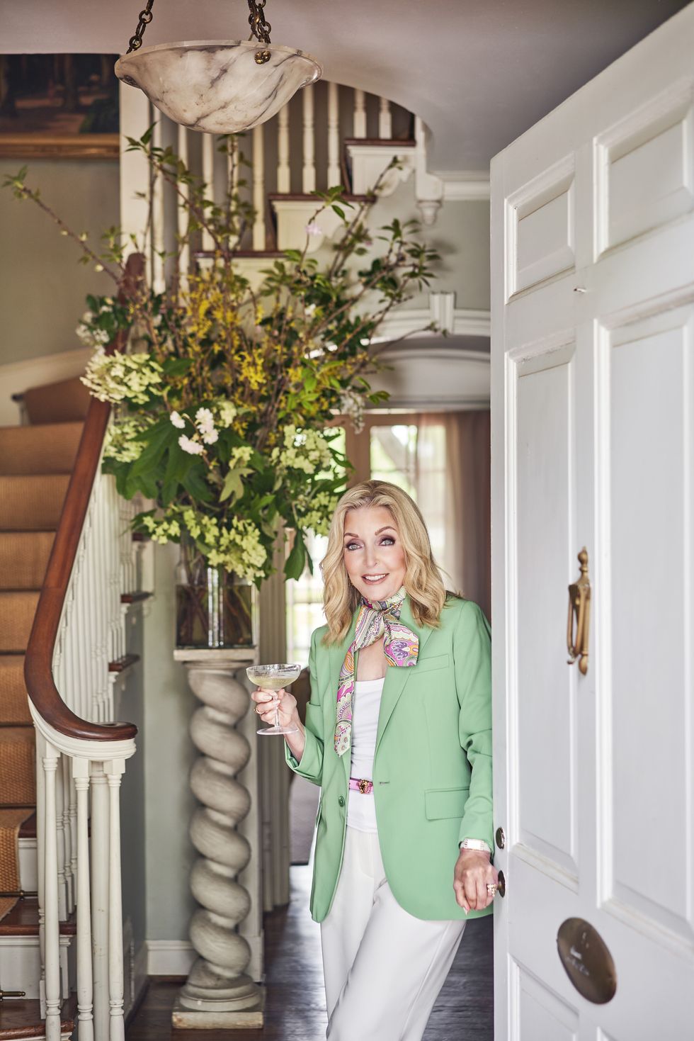the interior designer welcomes guests into her 1930s home with a cool glass of champagne