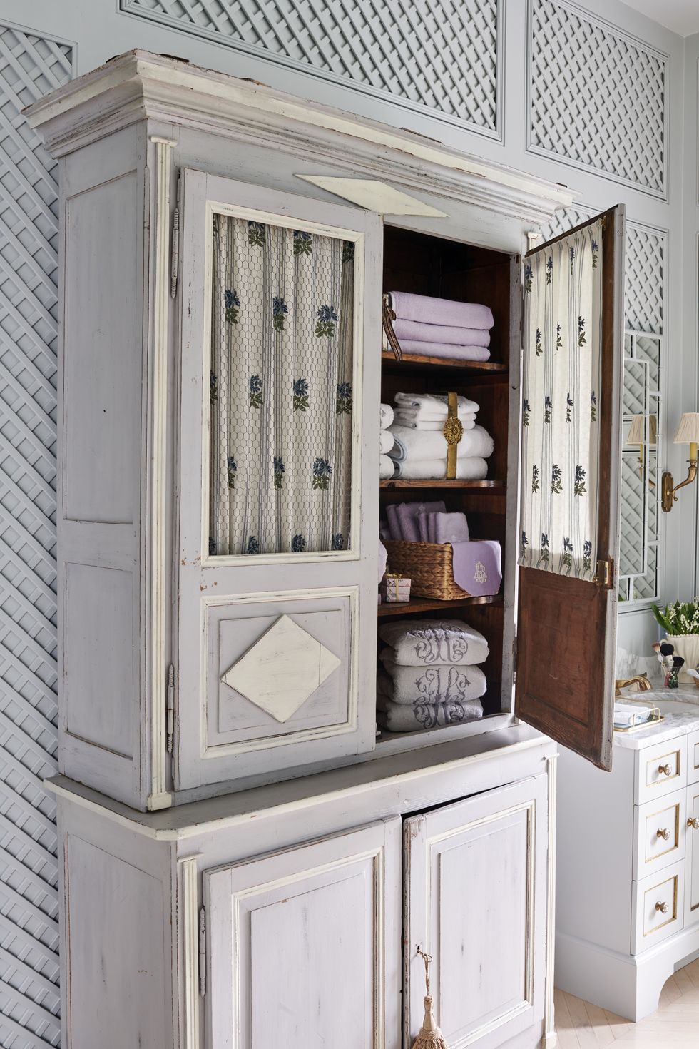 in the bathrooma painted armoire houses plush terry towels