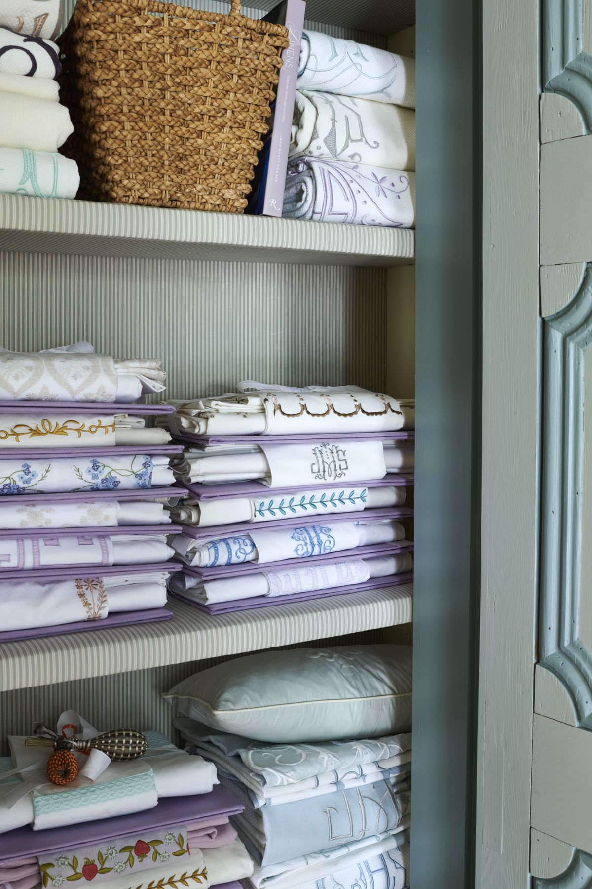 a closet in the bedroom’ entry vestibule holds hodges largest cache of exquisitely organized bedding and after a good ironing a matching flat sheet and pillow sham are folded to display their embroidery then tied to a linen board