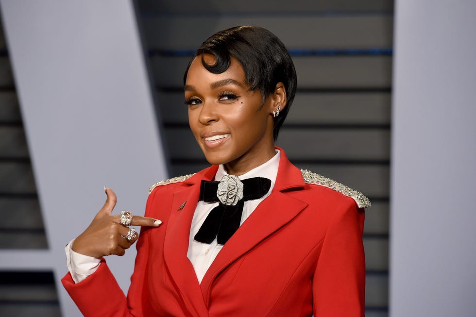 janelle monae in a red blazer with black bow and a slicked down pixie