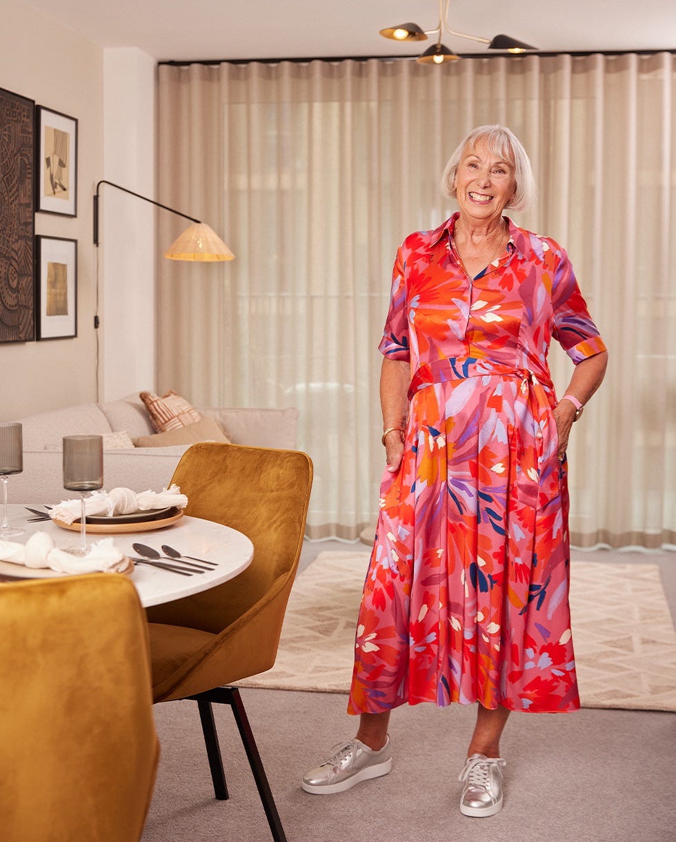 a colorful floral dress worn in a stylish apartment setting